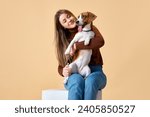 Small photo of Portrait of cute Beagle on hands of attractive happy smiling young woman. Love and friendship between dog and human. Concept of animal, pet lover, dogfriendly, domestic life, companionship.