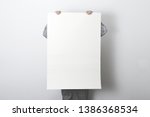 man holding white customizable empty poster