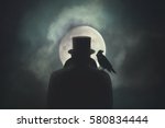 Man with crow on his shoulder observing the moon