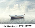 man relaxing on old boat floating in the calm water