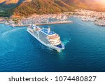 Cruise ship at harbor. Aerial view of beautiful large white ship at sunset. Landscape with boats, mountains, sea, blue sky. Top view of yacht. Luxury cruise. Floating liner in Europe. Travel. Resort