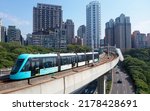 Small photo of A metro tram dashing on the elevated track of Danhai Light Rail Transit near Ganzhenlin Station, with booming residential towers in the nearby community, in Tamsui District, New Taipei City, Taiwan