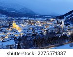 Small photo of Winter night scenery of Schladming, which is a popular tourist destination and winter-sports resort in Styria, Austria, with city lights glowing in the blue dusk and Dachstein mountains in background