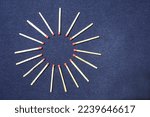 Small photo of Red headed phosphors of antimony sulfide and potassium chlorate in a circle, forms an abstract star design with a dark background