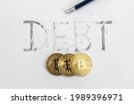 Small photo of Erasing debt with bitcoin. Debt written on white paper with a pencil, partially erased with an eraser. Symbolic for erasing debt.
