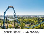 Small photo of Helsinki, Finland - 24 June 2022: Top view of Linnanmaki amusement park with roller coaster Taiga in blurred motion and Helsinki city.