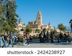 Small photo of 2023 09 23 Segovia, Spain. Touristat at Queen victoria eugenia square with the Catedral of Segovia on the background