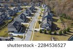 Small photo of Upscale new development two-story single-family houses with shingle roofing, swimming pool and well-trimmed yards lush greenery park tree suburbs Atlanta, Georgia, USA. Aerial large homes subdivision