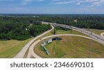 Small photo of Circular highway exit or ring road with railroad tunnel, large drainage system, overpass, viaduct off highway interstate 20 in Vicksburg, Mississippi. Aerial view beltline loop alternate route ramp