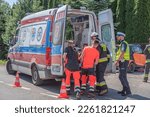 Small photo of 24.06.2021 skrzyszow, poland. Paramedics are putting someone to ambulance after accident. Policeman is looking at him. He needs help