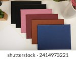 Colorful leather diploma holder. Concept shot, top view, different color, clamshell and stitched diploma holder, A new leather award board certificate and diploma frame