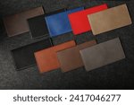 Small photo of Colorful leather checkbook. Genuine leather checkbook, concept shot, top view, different color, clamshell and stitched checkbook