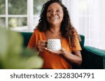 Female retiree taking a moment to unwind and enjoy a warm cup of tea in the comfort of her home, reflecting on the experiences and memories of a life well-lived.