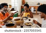 Small photo of Brazilian family gathering around the table for a traditional meal, sharing laughter and smiles. The table is filled with delicious dishes and the best of Brazilian cuisine, couve and feijoada.