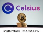 Small photo of Bitcoin tokens seen in front and blurred Celsius crypto company logo on the blurred background. Stafford, United Kingdom, July 14, 2022