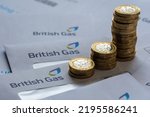 Small photo of Stacks of One Pound coins on top of British Gas bills in the envelopes. Concept for energy crisis and rising gas prices in the UK. Stafford, UK, August 29, 2022.