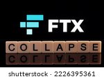 Small photo of COLLAPSE word made of letters seen in front and blurred FTX Cryptocurrency Exchange logo seen on display. Concept for company bankruptcy. Stafford, United Kindom, November 13, 2022.