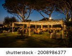 Marquee lit  at night in a  traditional  wedding in Italy, summer 2021. Garden  party in the open