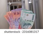 Small photo of Garut, Indonesia. April 22, 2023. New issuance of Indonesian Rupiah Banknotes in 2022. Rupiah banknotes with a nominal value of five thousand, ten thousand and twenty thousand.