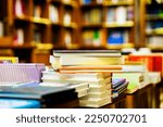 Small photo of Blurred bookstore with books on tables and shelves. Education, school, study, reading fiction concept