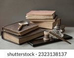 Small photo of Antic books, set of old stationery, wooden pen, inkwell, magnifier close-up on desk, vintage background. Concept of reading and education, memory and nostalgy
