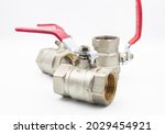 Stainless ball valve two way. Water valve isolated on white background. Valve with red handle.