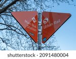 Small photo of Berlin Charlottenburg, 2021: An orange signpost near the fairgrounds to the destinations ZOB, Main Bus station to the left and to the S-Bahn, urban rail to the right.