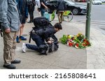 Small photo of Berlin 09 June 2022: A day after the rampage at Tauentzien, in which one person was killed and numerous injured, people lay flowers. A teacher killed after car ploughs into Kurfuerstendamm crowd.