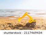 Toy Excavator On The Beach With ...
