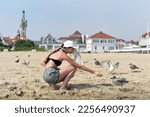 A Young Girl Feeds Seagulls