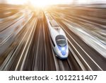 High-speed passenger train travels at high speed. Top view with motion effect, greased background