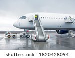 Wide body aircraft with ladder stairs to the airport parking