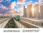 Suburban passenger rail transport, overground metro among skyscrapers in a modern city