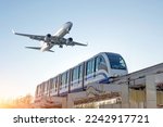View railway track and suburban electric monorail train rushing to . Passenger plane flying in sky, landing at airport. Concept of modern infrastructure transport travel.