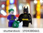 Small photo of surabaya, Indonesia- march 12, 2021: joker want share a sack of money that he stole to the batman. lego minifigs are made by the lego group.