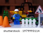 Small photo of Tangsel, Indonesia - April 29, 2021: lego guy minifigs push the green handcart in construction site. lego minifigs are made by the lego group.