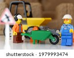 Small photo of Tangsel, Indonesia - April 30, 2021: two minifigs construction guy do some road repair. lego minifigs are made by the lego group.