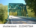 Green Overarching Bridge Covering the Road