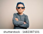 Small photo of Young little caucasian kid wearing internet meme thug life glasses over isolated background skeptic and nervous, disapproving expression on face with crossed arms. Negative person.