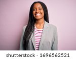 Young african american business woman standing over pink isolated background with a happy and cool smile on face. Lucky person.