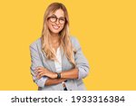 Beautiful blonde young woman wearing business clothes happy face smiling with crossed arms looking at the camera. positive person. 