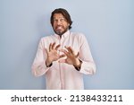 Small photo of Handsome middle age man wearing elegant shirt background disgusted expression, displeased and fearful doing disgust face because aversion reaction.
