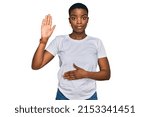 Small photo of Young african american woman wearing casual white t shirt swearing with hand on chest and open palm, making a loyalty promise oath