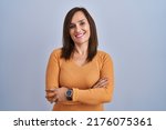 Small photo of Middle age brunette woman standing wearing orange sweater happy face smiling with crossed arms looking at the camera. positive person.