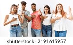 Small photo of Group of young friends standing together over isolated background smiling swearing with hand on chest and fingers up, making a loyalty promise oath