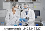 Small photo of In the heart of science, two committed scientists, a man and a woman, masked and gloved, steadfastly holding a critical medical sample in their lab, defiant against covid19.