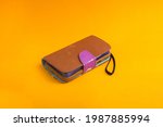 Old used brown case isolated on orange background