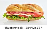 Small photo of Fresh baguette sandwich with ham, cheese, tomato and eruca sativa salad