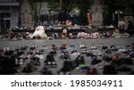 Small photo of Ottawa, Canada - June 2, 2021: People gather round and leave shoes and toys on Parliament Hill in memory of the 215 children whose remains were found near of former Residential School in Kamloops, B.C