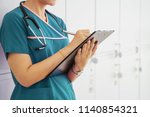 Woman Doctor Holding A Chart In ...
